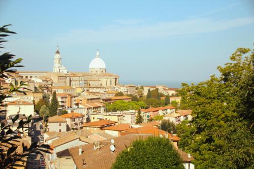 a view of a city with a cathedral in the background at Giolo House in Loreto