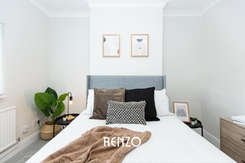 a bedroom with a white bed with a rico blanket on it at Charming 2-bed Home in Nottingham by Renzo, Driveway Parking! in Nottingham