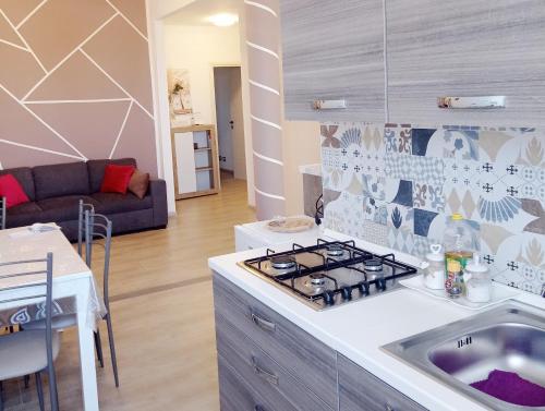 a kitchen with a sink and a stove top oven at La dimora di Sandy in Viterbo