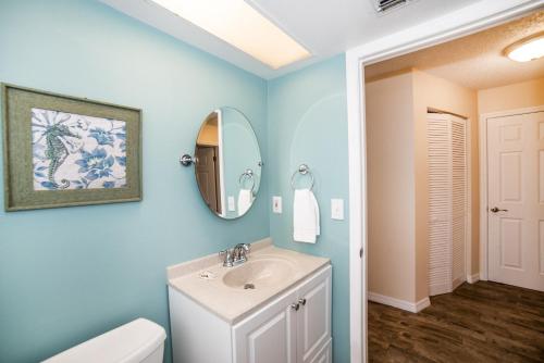 a bathroom with a sink and a mirror at Tropical Indian Rocks Beach suite B in Clearwater Beach