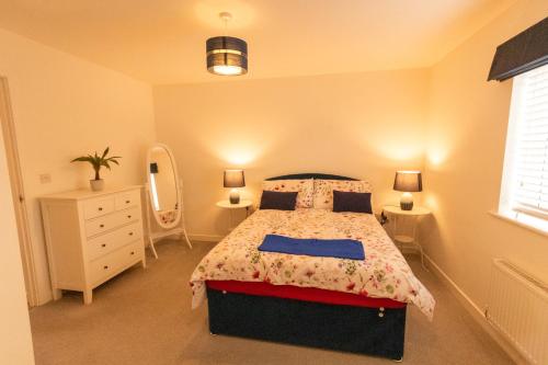 a bedroom with a bed and a dresser and a mirror at Arabian Nights in Swindon