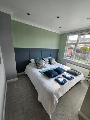 a bedroom with a large bed with pillows on it at Leyland House, 3 Bedroom, Parking Space, Coventry CV5 in Allesley