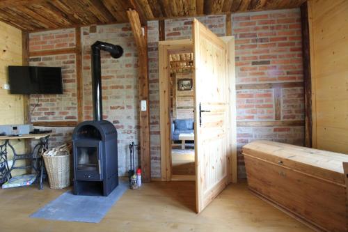 a wood stove in a room with a brick wall at Ferienhaus Anno Dazumal, wie zu Großmutters Zeiten in Klingenthal
