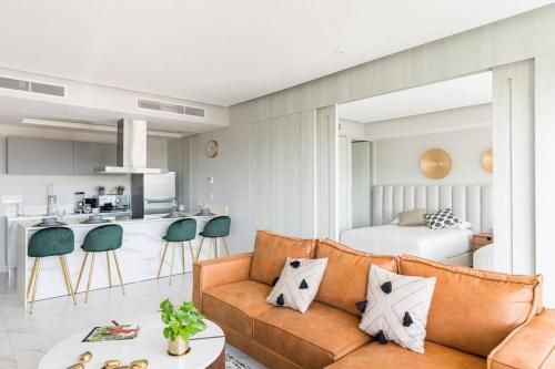 a living room with a couch and a kitchen at Luxury Condo On The Marina in Puerto Vallarta