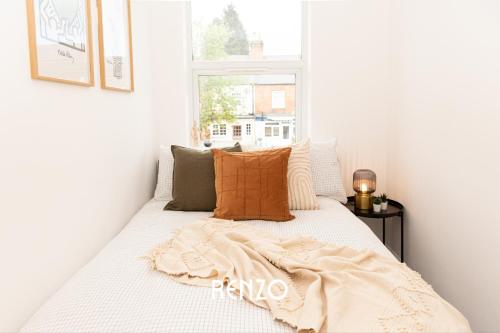 a bed in a room with a window at Beautiful 2-bed Home in Nottingham by Renzo, Free Wi-Fi, Ideal for Contractors in Nottingham