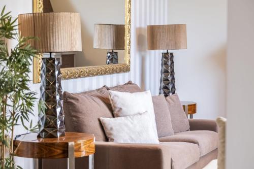 a living room with a couch and two lamps at Casa Olimpo by Homie in Estreito de Câmara de Lobos