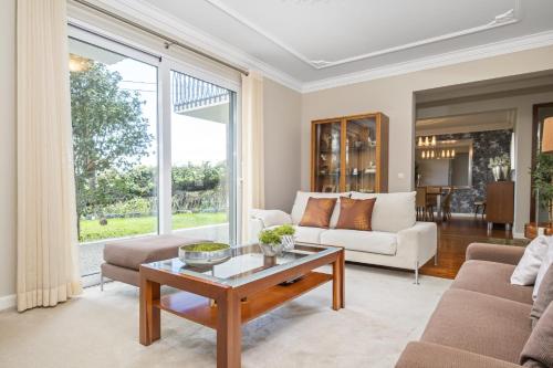 a living room with a couch and a table at Casa Olimpo by Homie in Estreito de Câmara de Lobos