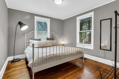 a bedroom with a bed and two windows at Southern Comfort in Atlanta