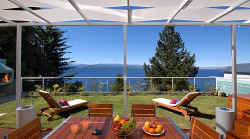 a patio with a table with fruit on it at Luxury Lake Views Apartments By Apartments Bariloche in San Carlos de Bariloche