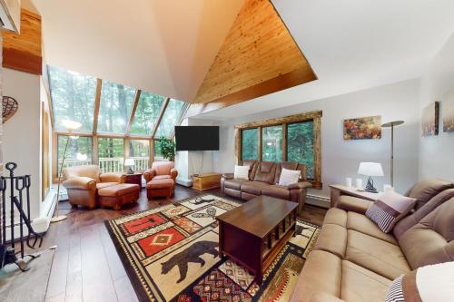 a living room with a couch and a table at Birch Landing #1 in Plymouth