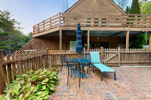 a patio with a table and chairs in front of a house at Birch Landing #1 in Plymouth