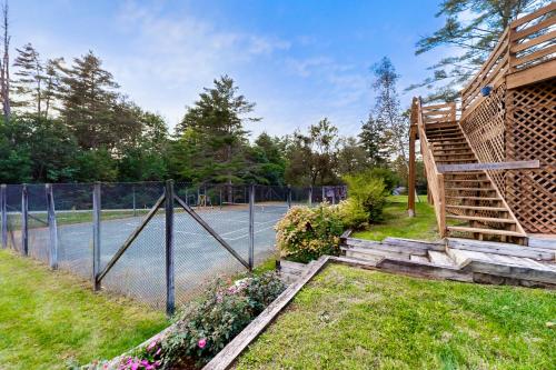 a garden with a fence and a wooden staircase at Birch Landing #1 in Plymouth
