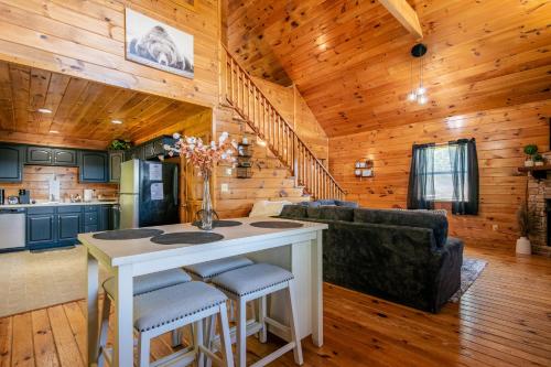 a kitchen and living room in a log cabin at Southern Grace in Pigeon Forge