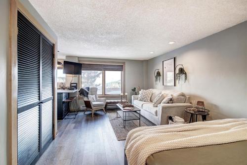 a bedroom with a bed and a living room at Village at Breck Studio 4217 in Breckenridge