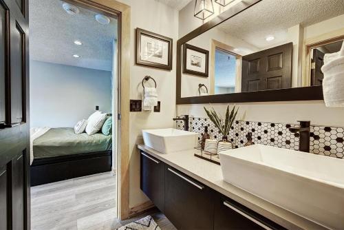a bathroom with two sinks and a bedroom at Village at Breck Studio 4217 in Breckenridge