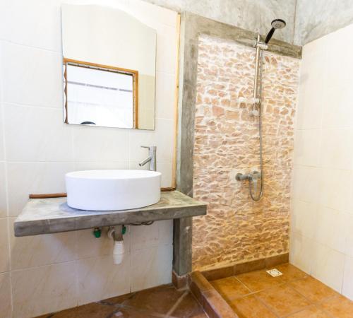 a bathroom with a sink and a shower at Royal Sakalava in Diego Suarez