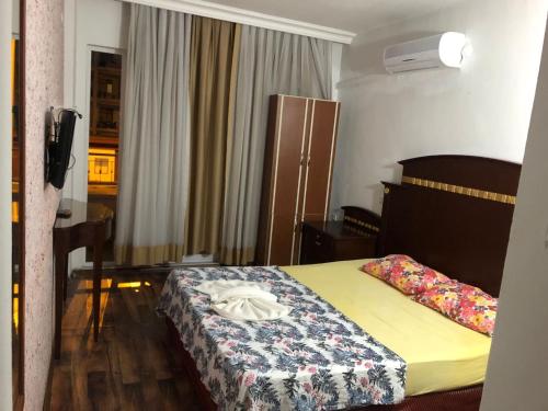 a hotel room with a bed and a window at Anamur Butik Otel in Anamur