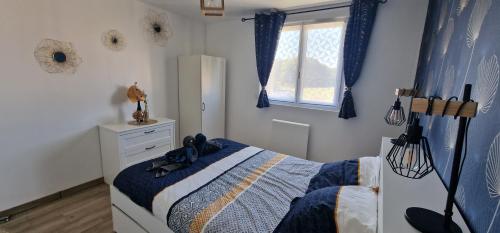a bedroom with a bed and a window at L'étape champenoise appartement in Bouy