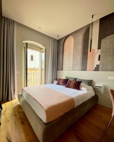 a bedroom with a large bed in a room at Nonno Nicola Rooms in Bari