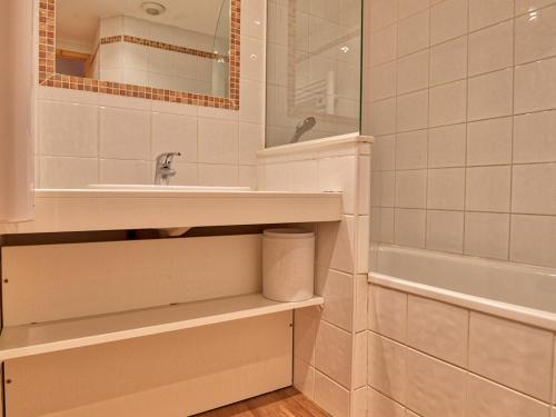 a bathroom with a sink and a mirror and a tub at Duplex 4 chambres avec piscine et parking au centre du village - 10 pers - FR-1-505-122 in Notre-Dame-de-Bellecombe