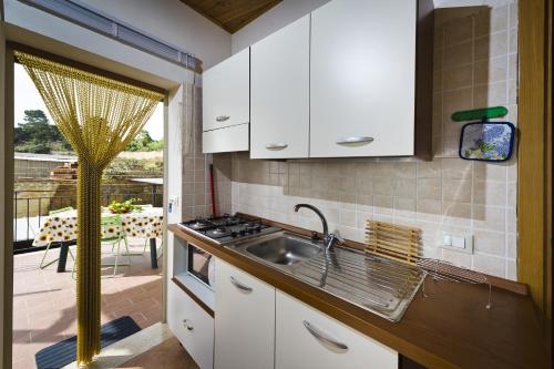 a kitchen with a sink and a stove at Trivani a 100 m dal mare in Castellammare del Golfo