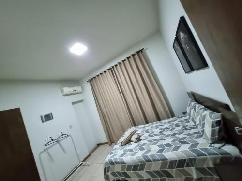 um quarto com uma cama e uma televisão na parede em Casa inteira Ipatinga em Ipatinga