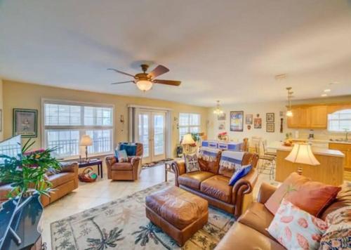 a living room with couches and a ceiling fan at Maldonado Beach House in Pensacola Beach
