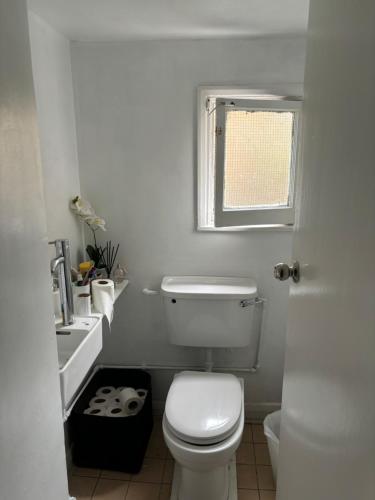 ein Bad mit einem WC, einem Waschbecken und einem Fenster in der Unterkunft Stay in Kings Cross in London