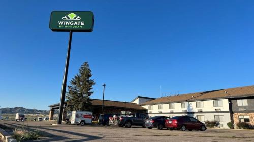 a sign in a parking lot in front of a building at Wingate by Wyndham Beaver I-15 in Beaver