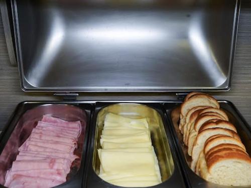 a lunch box with different types of sandwiches and bread at Attiê Park Hotel in Uberlândia