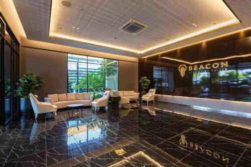 a lobby of a hotel with couches and chairs at Beacon Executive Suite by Uptrend Home Management in George Town