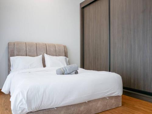 a bed with a teddy bear sitting on top of it at Beacon Executive Suite by Uptrend Home Management in George Town