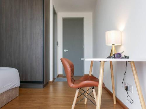 a bedroom with a desk and a chair and a bed at Beacon Executive Suite by Uptrend Home Management in George Town