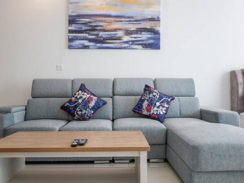 a living room with a couch and a coffee table at Beacon Executive Suite by Uptrend Home Management in George Town