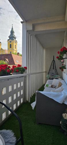 a balcony with a table and chairs on a roof at ANNA GYÖNGYE APARTMAN DEBRECEN in Debrecen