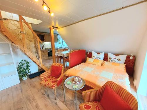a bedroom with a bed and a table and chairs at Komfortferienwohnung Anker & Steuerrad in Putbus
