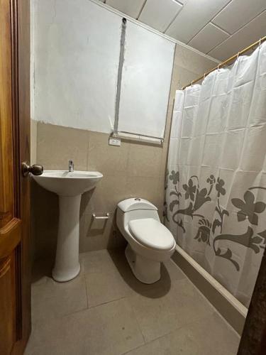 a bathroom with a toilet and a sink at Casa Terra in Cuenca