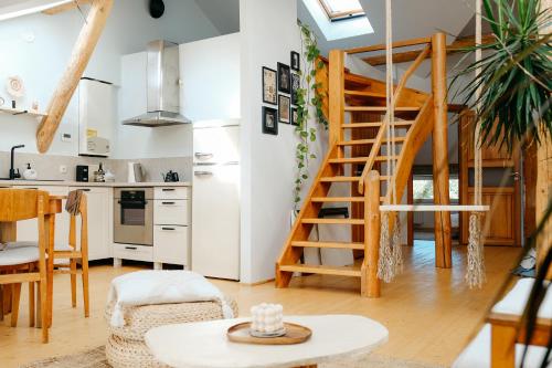 a kitchen and a living room with a spiral staircase at White Loft in the Riga City Center in Rīga