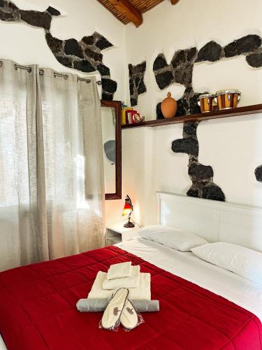 a bedroom with a bed with two towels on it at Terre Villa Katia in Santa Maria di Licodia