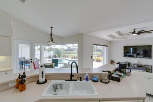 cocina con fregadero y vistas a la piscina en Canal Front Rotonda West Home By Beach, en Rotunda-West