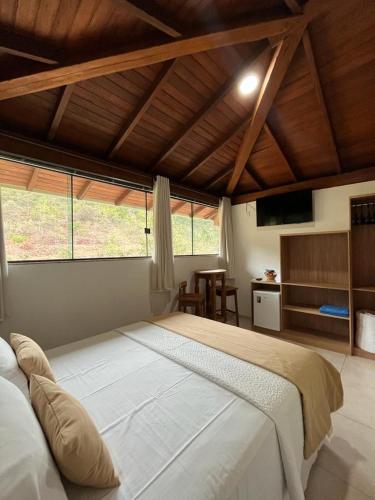 a large bedroom with a large bed in a room at Pousada Mar Mineiro Macacos in Nova Lima