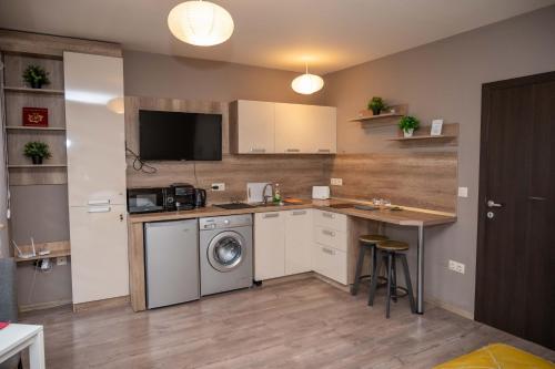 a kitchen with a washer and dryer in a room at All Seasons Apartments Iglika 2 in Borovets