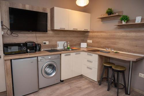 a kitchen with a sink and a washing machine at All Seasons Apartments Iglika 2 in Borovets