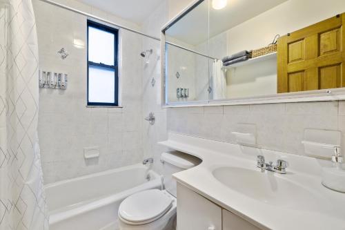 a bathroom with a sink and a toilet and a tub at Central Living at Columbia university in New York