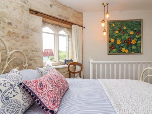 a bedroom with a bed and a window at Butterrow Gate in Stroud