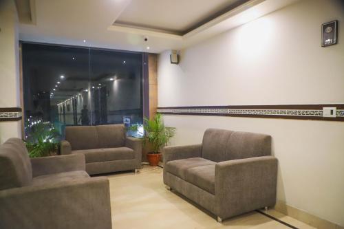 a waiting room with two chairs and a large screen at Hotel Central Palace in Dehradun