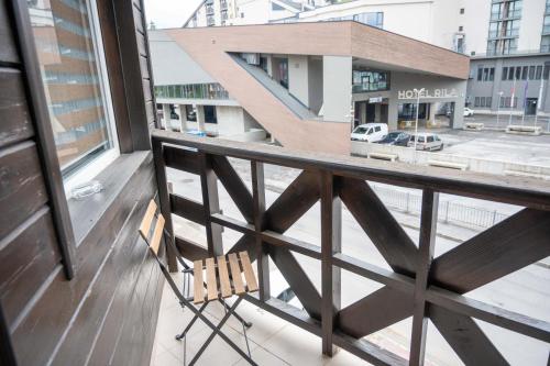 a chair sitting on the balcony of a building at All Seasons Apartments Iglika 2 in Borovets