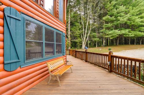 a bench sitting on a wooden deck next to a building at Gated Community with Perks Cozy Sparta Cabin! in Whitehead