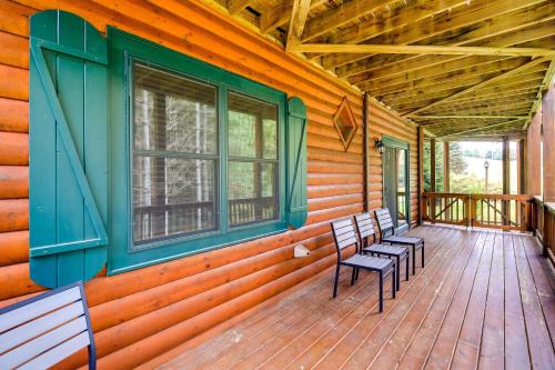a porch with chairs and windows on a cabin at Gated Community with Perks Cozy Sparta Cabin! in Whitehead