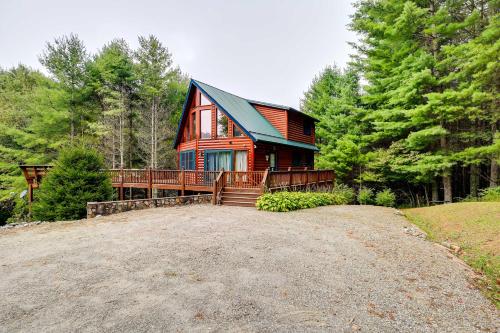 a red house with a large driveway in the woods at Gated Community with Perks Cozy Sparta Cabin! in Whitehead
